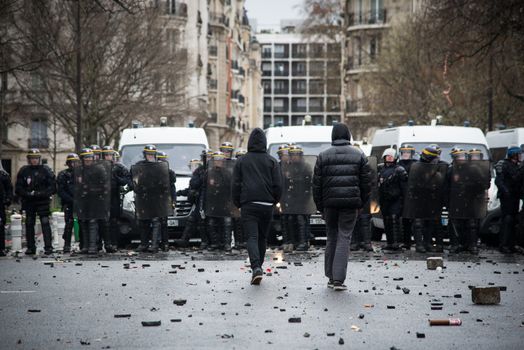 FRANCE, Paris: Protesters face riot policemen during a demo on April 9, 2016 in Paris, against the French government's proposed labour law reforms.