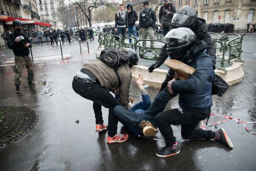 FRANCE, Paris: Policemen arrest a protester during a demo on April 9, 2016 in Paris, against the French government's proposed labour law reforms.