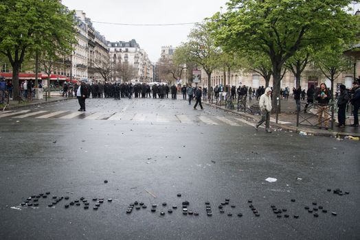 FRANCE, Paris: A picture shows a message written on the ground by protesters Etat policier (police state) during a demo on April 9, 2016 in Paris, against the French government's proposed labour law reforms.