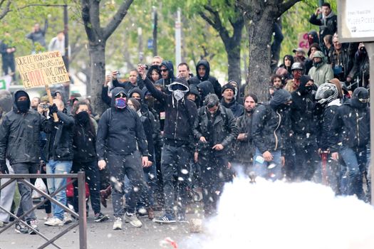 FRANCE, Paris: Masked protesters stand together during a demo on April 9, 2016 in Paris, against the French government's proposed labour law reforms.