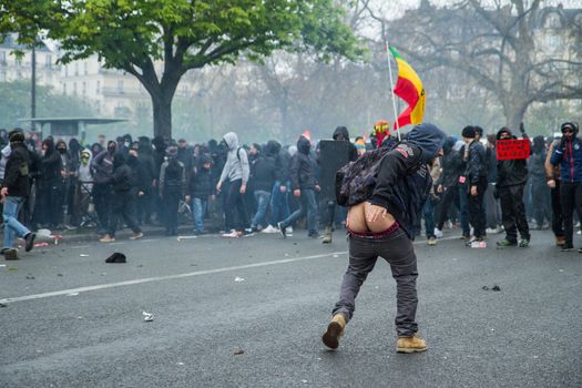 FRANCE, Paris: A protester shows his butt to riot policemen during a demo on April 9, 2016 in Paris, against the French government's proposed labour law reforms.