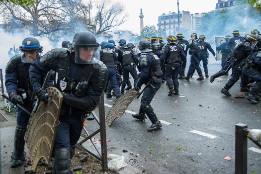FRANCE, Paris: Riot policemen remove dangerous metal items during a demo on April 9, 2016 in Paris, against the French government's proposed labour law reforms.