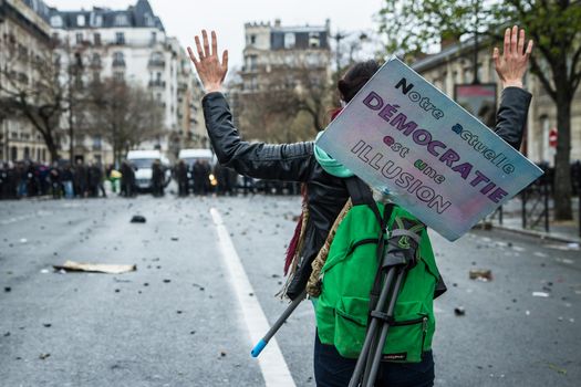 FRANCE, Paris: A protester showing hands stands in front of riot policemen during a demo on April 9, 2016 in Paris, against the French government's proposed labour law reforms.