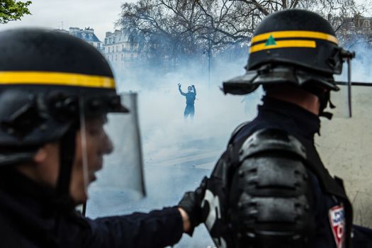 FRANCE, Paris: A protester showing hands stands in front of riot policemen during a demo on April 9, 2016 in Paris, against the French government's proposed labour law reforms.