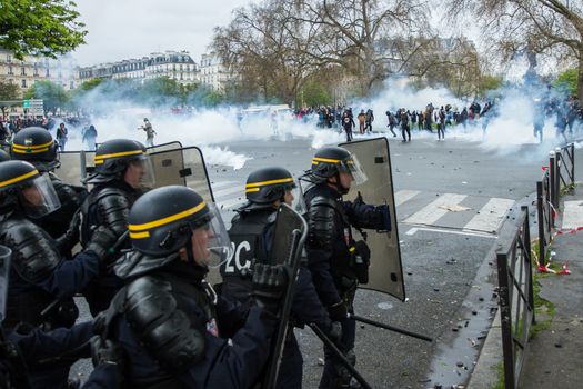 FRANCE, Paris: Riot policemen face protesters during a demo on April 9, 2016 in Paris, against the French government's proposed labour law reforms.
