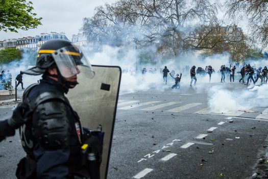FRANCE, Paris: A riot policeman faces protesters during a demo on April 9, 2016 in Paris, against the French government's proposed labour law reforms.