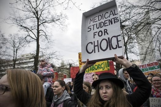 POLAND, Warsaw: People attend an anti-government and pro-abortion demonstration in front of parliament, on April 9, 2016 in Warsaw. The banner reads 'Medical students for choice'. 