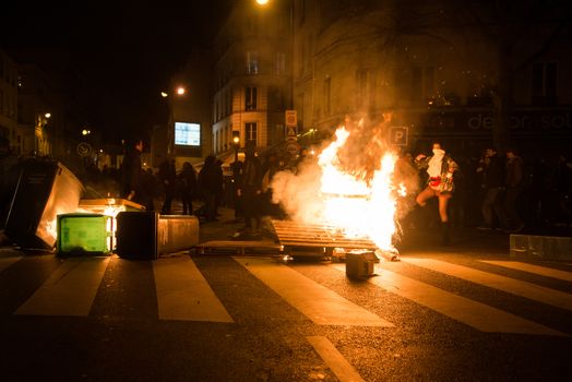 FRANCE, Paris: Palets and dust bins burn in Paris, as Nuit Debout militants hold a spontaneous demonstration to reach French Prime minister Manuel Valls residence on April 9, 2016.