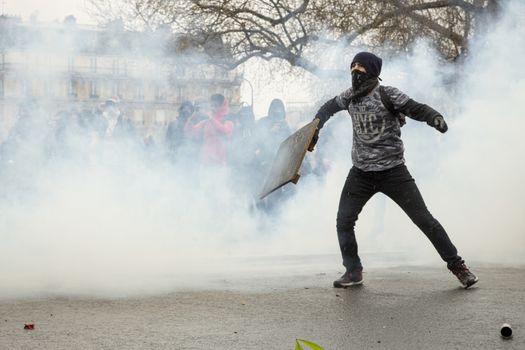 FRANCE, Paris: A protester faces riot police at the end of a demonstration against planned labour reforms, in Paris, France, on April 9, 2016.