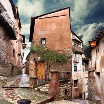 Surreal house and cobblestone village street at evening