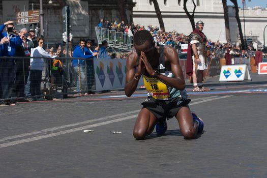 ITALY, Rome: Kenyan runner Amos Kipruto is pictured down on his knees as he won the finish line of Rome City Marathon  in Rome on April 10, 2016. He won the first position in 2h08'16”.