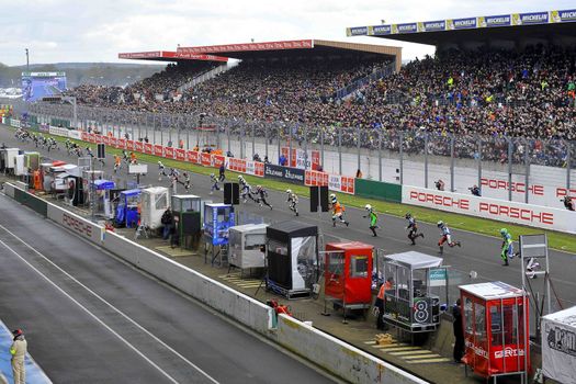 FRANCE, Le Mans: Pilots run at the start of Le Mans 24 Hours moto endurance race at Bugatti track in Le Mans, France, on April 9, 2016.