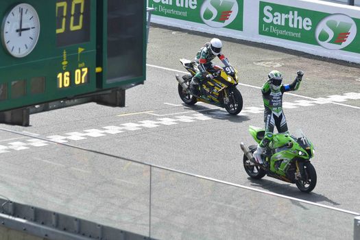 FRANCE, Le Mans: French rider Gregory Leblanc on Kawasaki ZX10R Formula EWC N°11 crosses the finish line and wins the 39th edition of le Mans 24 hours moto endurance race on April 10, 2014 in Le Mans, western France. French team Leblanc-Lagrive-Foret on Kawasaki N.11 won the race.