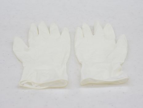 One pair of rubber medical gloves placed on table at patient room.