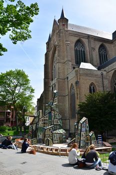 Bruges, Belgium - May 11, 2015: People at the plaza of St. Salvator's Cathedral in Bruges, Belgium. The Sint-Salvator Cathedral is the main church of the city.