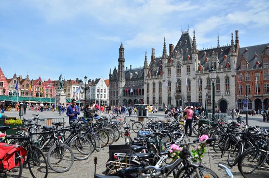 Bruges, Belgium - May 11, 2015: Tourist on Grote Markt square in Bruges, Belgium on May 11, 2015. The historic city centre is a prominent World Heritage Site of UNESCO.