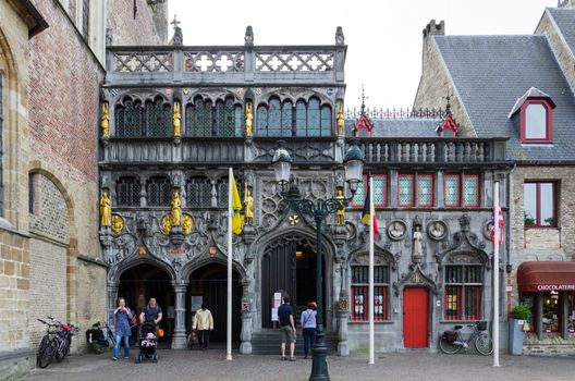 Bruges, Belgium - May 11, 2015: Tourist visit Basilica of the Holy Blood in Bruges, Belgium on May 11, 2015. Basilica is located in the Burg square and consists of a lower and upper chapel.