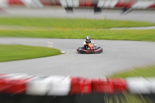 go-kart pilot is racing a race in an outdoor go karting circuit 