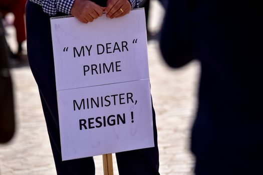 MALTA, Valletta: A protestor holds a sign reading My dear Prime minister resign! during a demonstration calling on Maltese Prime minister Joseph Muscat to resign after two members of his government were named in the Panama Papers leak scandal, outside the office of the Prime minister in Valletta, in Malta, on April 10, 2016. 
