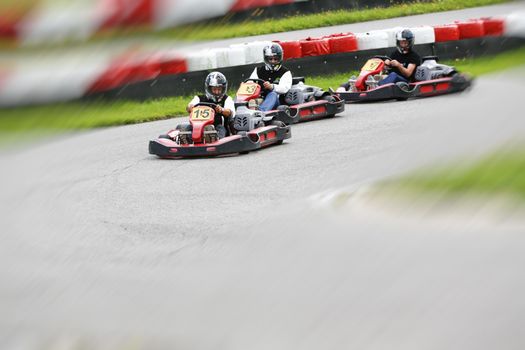 go-kart pilot is racing a race in an outdoor go karting circuit 