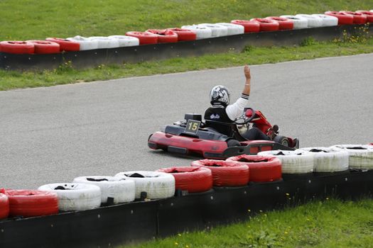 go-kart pilot is racing a race in an outdoor go karting circuit 