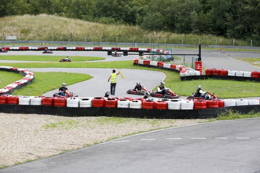 go-kart pilot is racing a race in an outdoor go karting circuit 