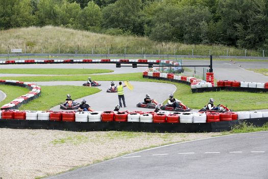 go-kart pilot is racing a race in an outdoor go karting circuit 