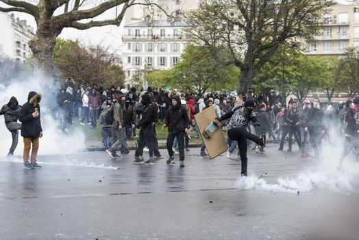 FRANCE, Paris: A protester shoots in a tear gas can during a demo on April 9, 2016 in Paris, against the French government's proposed labour law reforms.