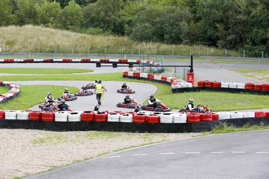 go-kart pilot is racing a race in an outdoor go karting circuit 