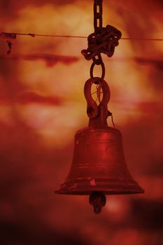  An old bell in a hindu temple in saffron color light effect which represents official Hinduism color.