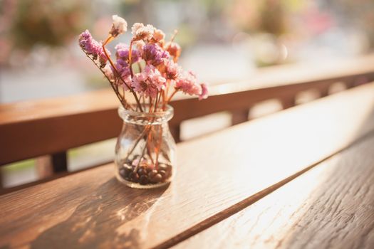 A small plant pot on wood vintage color .