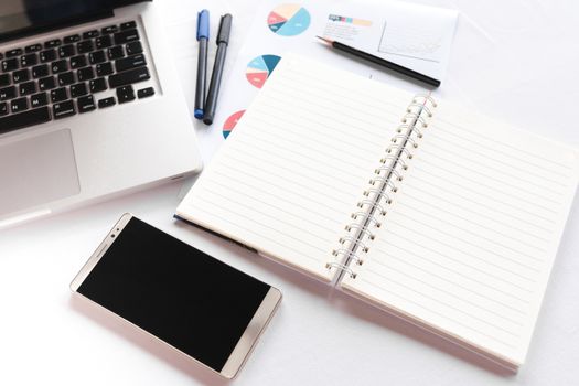 Blank note book with pencil pen laptop and smartphone on white table concept and Idea for write your text here.