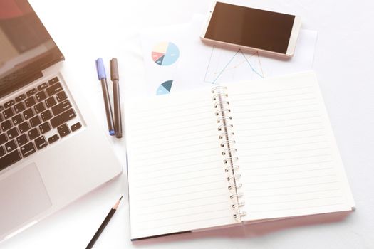 Blank note book with pencil pen laptop and smartphone on white table concept and Idea for write your text here.