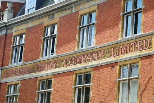 Frontage of red brick building with diary  company sign