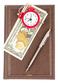 Leather daily planner with pen and cash and alarm clock on isolated white background