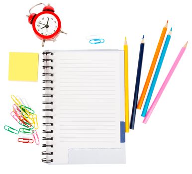 Open notebook with stationery and alarm clock isolated white background, closeup