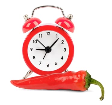 Red hot pepper with red alarm clock on isolated white background
