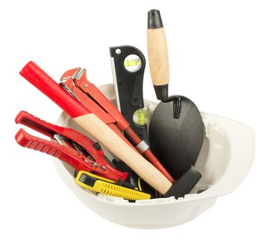 Construction worker supplies including  white hard hat on isolated white background