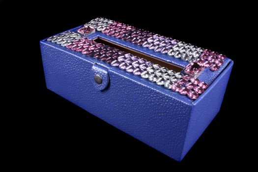 A luxurious tissue box in violet color designed with gemstones.