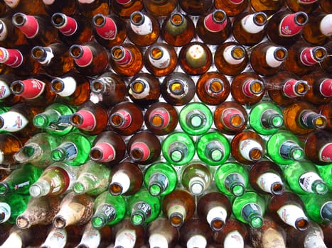 A background of beer bottles with their open side facing the camera.