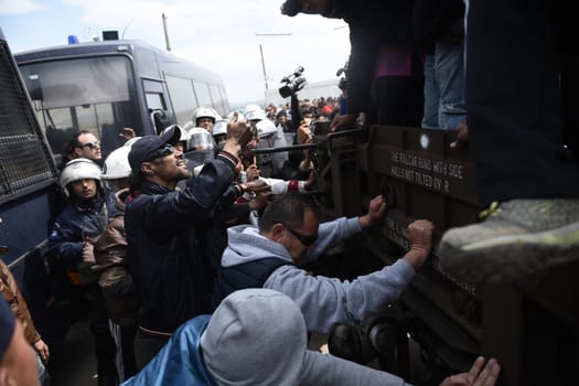 GREECE, Idomeni: Migrants surround a truck in the Idomeni camp on April 11, 2016, one day after the clashes with the Macedonian police.Hundreds of migrants were injured on Sunday as they attempted to cross the border into Macedonia. Police used tear gas, water cannons, and stun grenades to disperse the crowd as migrants threw stones in retaliation. 