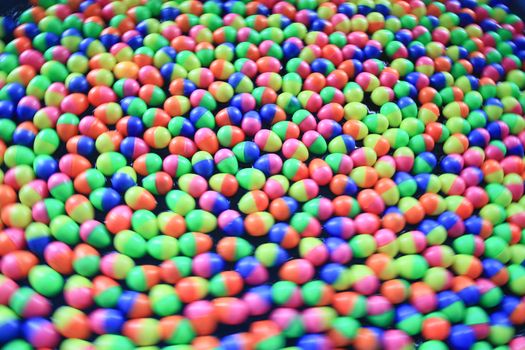 colorful plastic eggs floating on the water background