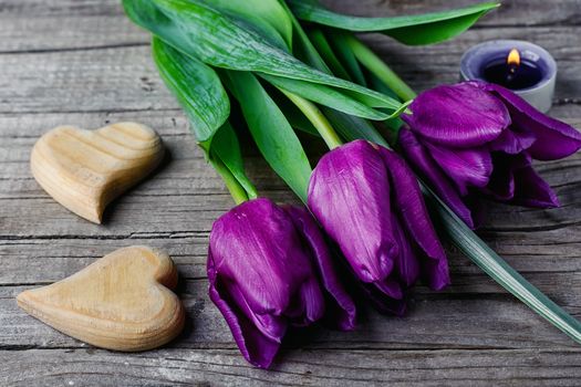 Three tulips and two symbolic hearts of wood