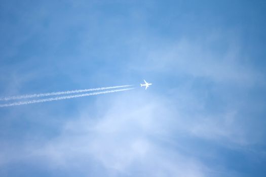 A long trail of jet plane on blue sky