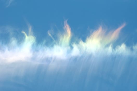 rainbow in cloud on bluesky