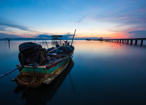 Thai fishing boat used as a vehicle for finding fish in the sea.at sunset