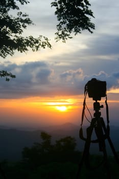 Silhouette of a camera on tripod