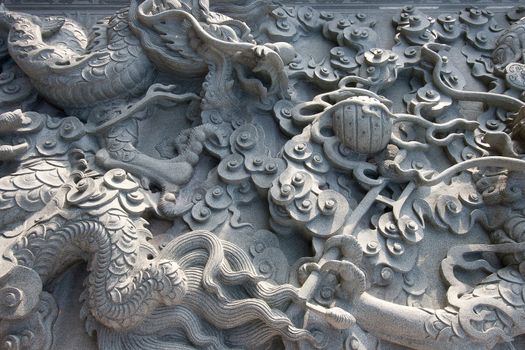 Chinese dragons on granite wall texture