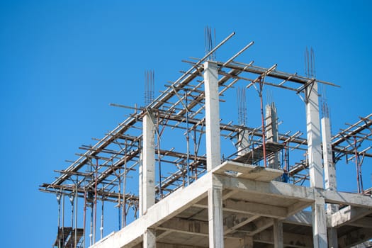 Building construction site work against blue sky