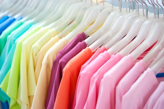 Colorful t-shirt on hangers